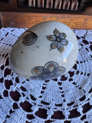 Sale Photo Thumbnail #84: A vintage hand-painted stoneware egg figurine by Ken Edwards (El Palomar), crafted in Tonala, Mexico. Features a classic bird and floral motif in muted blue, grey, and brown tones over a crackle-glazed cream background. Measures approximately 3 to 4 inche