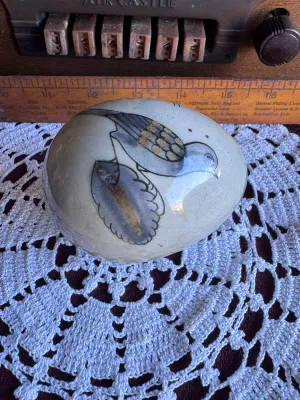 Sale Photo Thumbnail #83: A vintage hand-painted stoneware egg figurine by Ken Edwards (El Palomar), crafted in Tonala, Mexico. Features a classic bird and floral motif in muted blue, grey, and brown tones over a crackle-glazed cream background. Measures approximately 3 to 4 inche