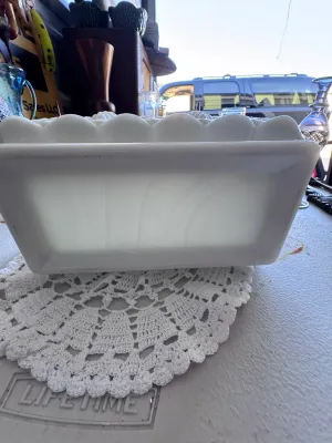 Sale Photo Thumbnail #339: A vintage milk glass rectangular planter or centerpiece bowl featuring the classic 'Paneled Grape' pattern by Westmoreland Glass. It features a scalloped rim, embossed grape clusters, and leaves on the exterior panels. The bottom interior shows the faint 