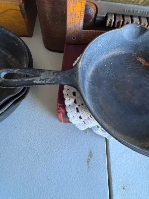 Sale Photo Thumbnail #267: An authentic vintage Griswold No. 5 cast iron skillet, model number 724 G. Made in Erie, Pennsylvania, USA. Features the classic Griswold small logo marking on the bottom. The skillet shows signs of age and use, including surface wear, some build-up, and 