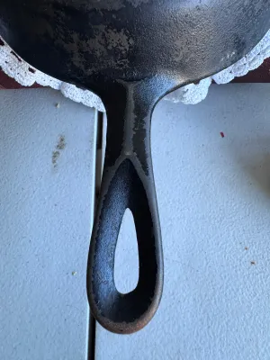 Sale Photo Thumbnail #265: An authentic vintage Griswold No. 5 cast iron skillet, model number 724 G. Made in Erie, Pennsylvania, USA. Features the classic Griswold small logo marking on the bottom. The skillet shows signs of age and use, including surface wear, some build-up, and 