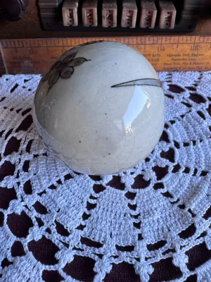Sale Photo Thumbnail #85: A vintage hand-painted stoneware egg figurine by Ken Edwards (El Palomar), crafted in Tonala, Mexico. Features a classic bird and floral motif in muted blue, grey, and brown tones over a crackle-glazed cream background. Measures approximately 3 to 4 inche
