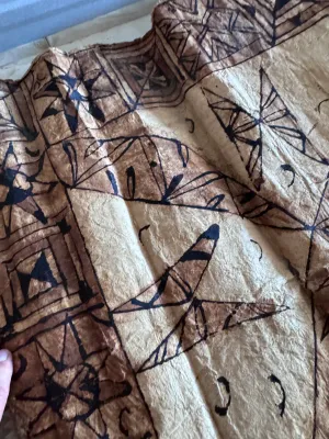 Sale Photo Thumbnail #131: A vintage Pacific Island tapa cloth (siapo / masi), handcrafted from the inner bark of the paper mulberry tree. Features traditional hand-painted geometric patterns, star motifs, and leaf designs in natural brown and black pigments. Shows authentic textur