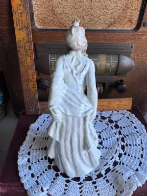 Sale Photo Thumbnail #79: An elegant vintage porcelain figurine depicting the Frog King (Der Froschkönig) fairy tale, featuring a princess with a golden crown looking down at a small green frog with a golden ball. Produced by the renowned maker Rosenthal in Germany. Designed by L