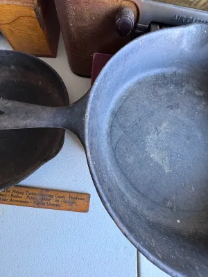Sale Photo Thumbnail #278: A vintage cast iron skillet featuring the distinctive teardrop-shaped handle hole and number marking characteristic of the Chicago Hardware Foundry (CHF), made in North Chicago, Illinois. The bottom shows a raised number '4' and a diamond mark. The skille