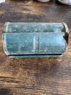 Sale Photo Thumbnail #224: A vintage Bob-Bet Bait Box featuring a cylindrical green metal body on a stand. The front label reads, "BOB-BET BAIT BOX - JUST HALF A TURN AND THERE'S YOUR WORM." The item shows significant vintage wear, including rust, paint loss, and surface grime cons