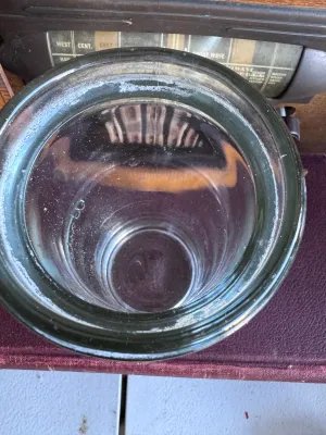 Sale Photo Thumbnail #291: A vintage clear glass battery jar manufactured by Whitall Tatum Co. in Millville, New Jersey. The jar features the embossed script "Whitall" on the front side and is embossed on the bottom rim with "WHITALL TATUM CO. MILLVILLE N.J. U.S.A.". It stands appr