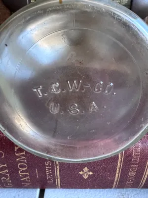 Sale Photo Thumbnail #344: An antique or vintage clear glass apothecary/chemical bottle featuring its original ground glass stopper. The bottom is embossed with 'T.C.W. CO. U.S.A.', indicating it was manufactured by the T.C. Wheaton Glass Company in Millville, New Jersey, USA. The 