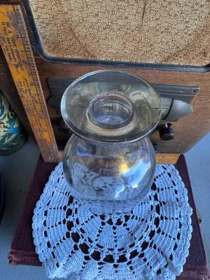 Sale Photo Thumbnail #245: A vintage clear glass liquor decanter or bottle featuring the embossed text on the bottom: "FEDERAL LAW FORBIDS SALE OR REUSE OF THIS BOTTLE". This phrase dates the bottle to the post-Prohibition era, specifically between 1935 and 1964. The bottom also fe