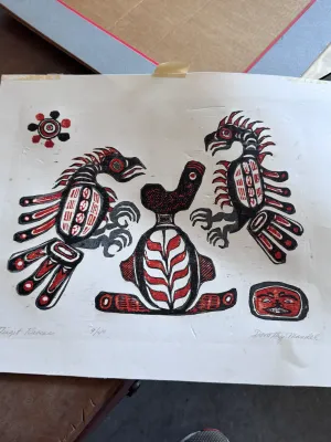 Sale Photo Thumbnail #173: An original limited edition woodblock or linocut print titled "Tlingit Ravens" by artist Dorothy Mandel. Hand-signed in pencil by the artist on the lower right, titled on the lower left, and numbered 9/40. The artwork features Northwest Coast Indigenous s