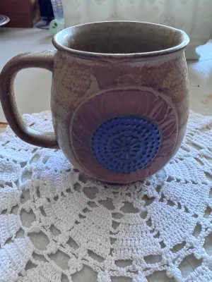Sale Photo Thumbnail #326: An eclectic collection of six vintage ceramic and stoneware mugs featuring distinct mid-century and retro designs. The set includes a brown mug marked 'W. Germany 926' on the bottom with stylized white floral/geometric patterns, a black mug with red spira