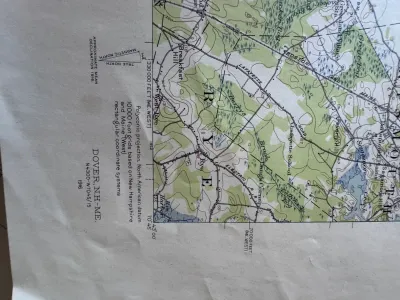 Sale Photo Thumbnail #205: An authentic vintage United States Geological Survey (USGS) topographic map of the Dover, N.H.-ME. quadrangle. Originally surveyed in 1916, this edition features a polyconic projection based on the North American datum. It details geographic features, roa