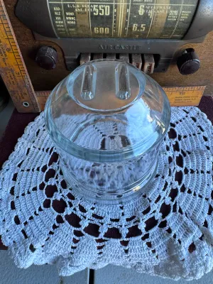 Sale Photo Thumbnail #241: A vintage replacement glass jar for a Dazey Churn No. 40. This heavy, clear glass jar features the characteristic round body with a wide mouth and the distinctive raised glass guide bars on the bottom interior/exterior base. It is in excellent vintage con