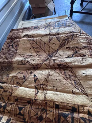 Sale Photo Thumbnail #128: A vintage Pacific Island tapa cloth (siapo / masi), handcrafted from the inner bark of the paper mulberry tree. Features traditional hand-painted geometric patterns, star motifs, and leaf designs in natural brown and black pigments. Shows authentic textur