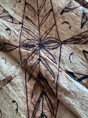 Sale Photo Thumbnail #130: A vintage Pacific Island tapa cloth (siapo / masi), handcrafted from the inner bark of the paper mulberry tree. Features traditional hand-painted geometric patterns, star motifs, and leaf designs in natural brown and black pigments. Shows authentic textur