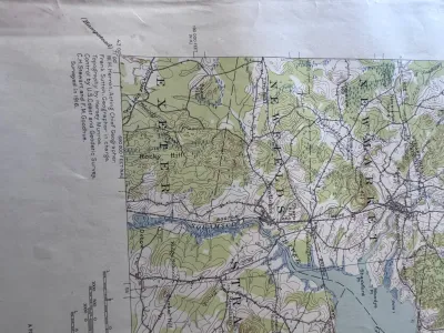 Sale Photo Thumbnail #203: An authentic vintage United States Geological Survey (USGS) topographic map of the Dover, N.H.-ME. quadrangle. Originally surveyed in 1916, this edition features a polyconic projection based on the North American datum. It details geographic features, roa