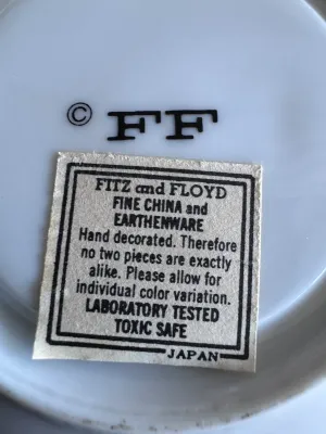 Sale Photo Thumbnail #63: A beautiful set of 5 vintage lidded tea cups with matching saucers by Fitz and Floyd. Each piece features a vibrant hand-decorated floral pattern in shades of blue, orange, and red. The bottoms are marked with the 'FF' copyright stamp, and one cup retains