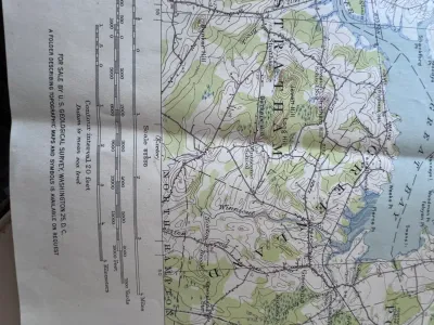 Sale Photo Thumbnail #204: An authentic vintage United States Geological Survey (USGS) topographic map of the Dover, N.H.-ME. quadrangle. Originally surveyed in 1916, this edition features a polyconic projection based on the North American datum. It details geographic features, roa