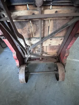 Sale Photo Thumbnail #20: An authentic antique Fairbanks wooden hand truck scale, combining a heavy-duty warehouse dolly with an integrated mechanical platform scale. Features a sturdy wood-plank bed, curved wooden handles, cast iron wheels, and the original mechanical weighing me