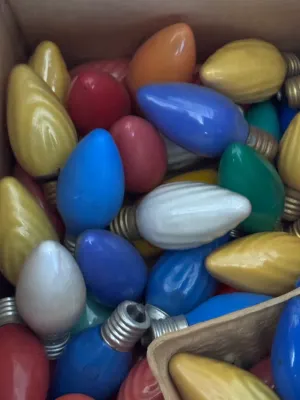 Sale Photo Thumbnail #113: A large estate collection of vintage Christmas lighting. Includes multiple green and red/pink insulated wire light strings with black sockets, a vintage red cardboard box of 'Twinkling Lamps' by World Wide, and a large assortment of loose ceramic and pain