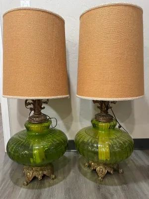 Sale Photo Thumbnail #12: Pair of mid-century modern green glass table lamps featuring ribbed, onion-shaped bodies, ornate brass bases and necks, and tall burlap drum shades with white trim.