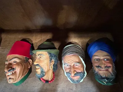 Sale Photo Thumbnail #14: Collection of four vintage Bossons chalkware character heads, including depictions of men in traditional headwear such as a fez, turban, and Tyrolean hat.