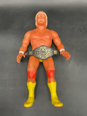 Vintage LJN WWF Hulk Hogan rubber action figure with championship belt, circa 1980s, showing some paint wear from play.