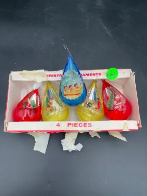 Vintage set of five teardrop-shaped plastic Christmas ornaments with diorama scenes inside, including carolers, Santa, and angels,...