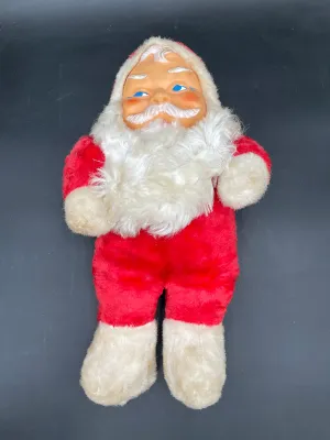 Vintage mid-century Santa Claus plush doll featuring a molded rubber face and white faux fur beard, showing some age-related wear.