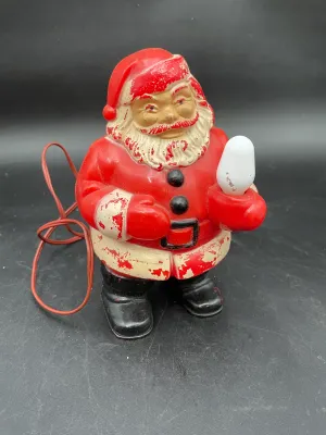 Vintage mid-century plastic Santa Claus blow mold light, showing significant paint wear and chipping consistent with age.