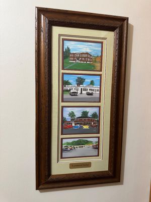 Sale Photo Thumbnail #17: Framed multi-panel art piece titled "A Sentimental Journey," featuring four nostalgic illustrations of vintage buildings and classic cars, housed in a ornate dark wood frame with double matting.