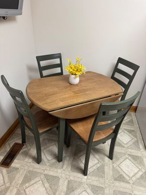 Sale Photo Thumbnail #14: Five-piece dining set featuring a wooden drop-leaf table with green legs and four matching ladder-back chairs with wooden seats.