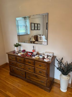 Sale Photo Thumbnail #22: Vintage wood triple dresser with brass batwing pulls, paired with a matching frameless beveled wall mirror.