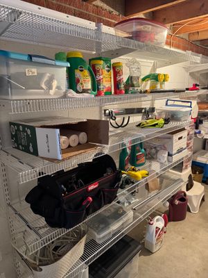 Sale Photo Thumbnail #28: White wire shelving unit holding various garage and garden supplies, including a Hyper Tough tool bag, lawn chemicals, and storage bins.
