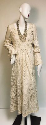 Vintage cream-colored lace maxi dress with long bell sleeves and a V-neckline, with a vintage  multi-strand pearl and rhinestone...