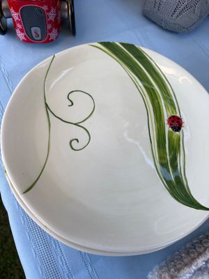 Sale Photo Thumbnail #37: Hand-painted ceramic plates featuring a whimsical ladybug on a green blade of grass design.