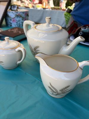 Sale Photo Thumbnail #54: Vintage mid-century porcelain tea service set featuring a teapot, creamer, and sugar bowl with a wheat motif and gold trim.