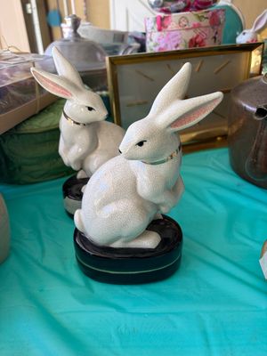 Sale Photo Thumbnail #17: Pair of vintage crackle-glazed ceramic rabbit figurines on black bases, featuring gold-accented collars and pink-shaded ears.