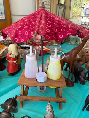 Sale Photo Thumbnail #8: Novelty picnic table condiment set featuring a miniature wooden picnic table with a red patterned umbrella, complete with squeeze bottles and salt and pepper shakers.