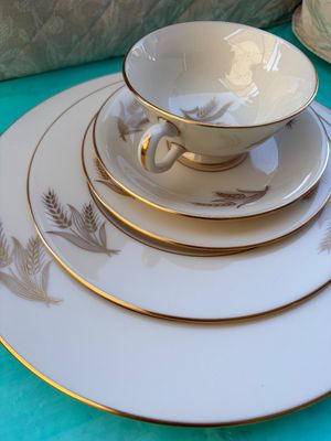 Sale Photo Thumbnail #66: Vintage fine china place setting featuring a gold wheat motif and gold-trimmed rims, including a teacup, saucer, and plates.