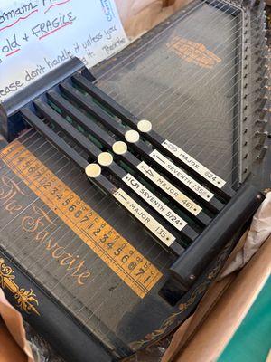 Sale Photo Thumbnail #20: Vintage Oscar Schmidt 'The Favorite' autoharp, featuring a black finish with gold stenciled lettering and five chord bars.