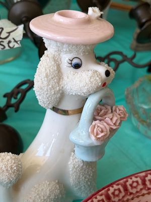 Sale Photo Thumbnail #86: Vintage spaghetti art porcelain poodle figurine wearing a pink hat and carrying a basket of pink roses, circa 1950s.