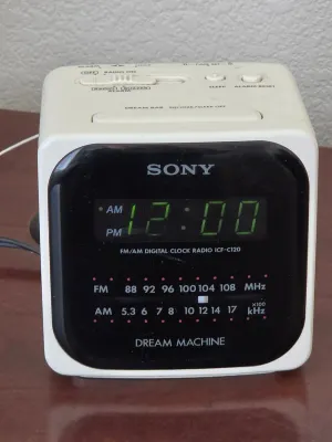 Vintage Sony Dream Machine ICF-C120 FM/AM digital clock radio in a white cube housing, showing a green LED display.