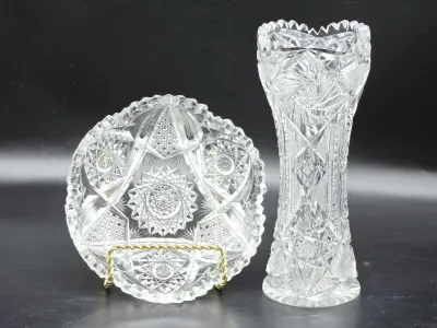 American Brilliant Period cut glass bowl on a brass stand alongside a matching corset-shaped vase, featuring intricate starburst and...