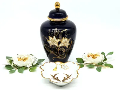 Vintage cobalt blue porcelain ginger jar with gold-gilded floral details, paired with a matching leaf-shaped trinket dish.