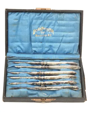 Antique set of six silver-plated nut picks by Landers, Frary & Clark, presented in their original blue satin-lined presentation box.