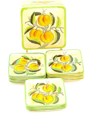 Vintage mid-century hand-painted papier-mâché coaster set with matching storage box, featuring a yellow peach and green leaf motif.