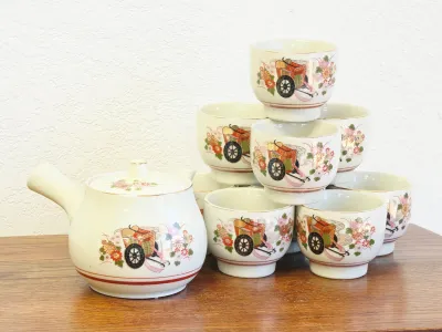 Vintage Japanese Kutani-style porcelain tea set featuring a side-handled kyusu teapot and matching handleless teacups decorated with a...