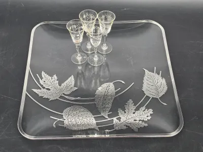 Mid-century Georges Briard glass serving tray featuring silver-toned leaf designs, accompanied by four matching etched cordial glasses.