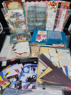 Large assortment of scrapbooking and crafting supplies, including stencils, stickers, patterned paper, die-cuts, and wooden letters.